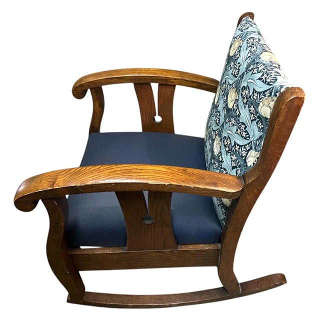 This magnificent, substantial, comfortable rocking chair is attributed to designer Leonard Wyburd for Liberty & Co. It is...