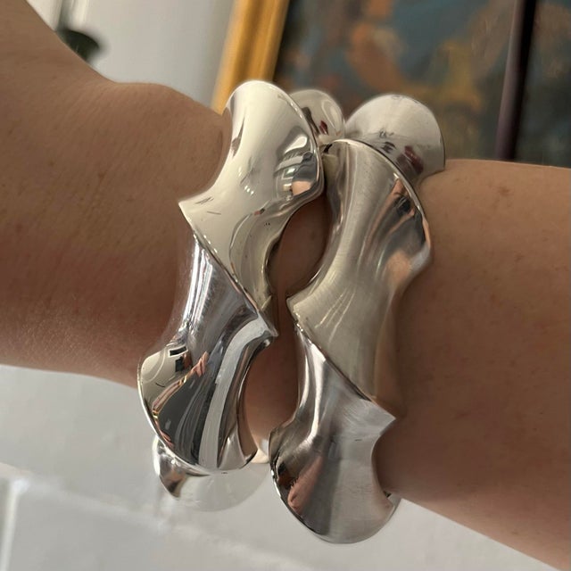 These high-fashion statement bracelets feature a highly reflective chrome finish and a contrasting matte, slightly darker...