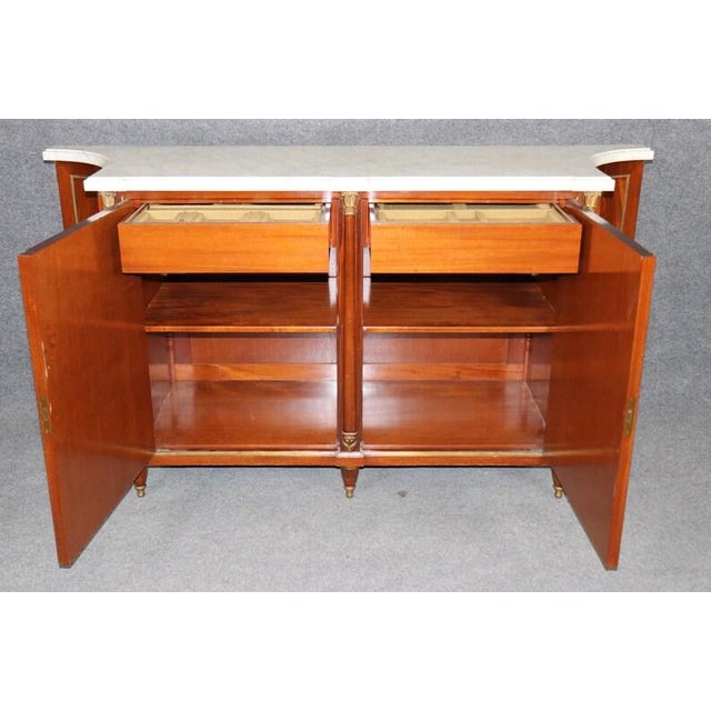 An investment-grade masterpiece by the legendary Parisian design house Maison Jansen. This Louis XVI style commode is a...