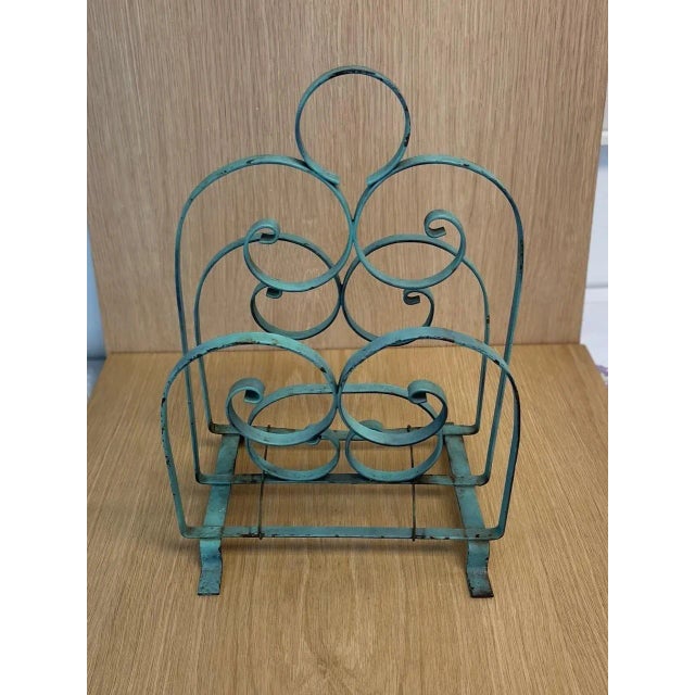 1940's Metal magazine rack, in a robin's egg blue color, all original components. 16”H x 11”W x 10”D overall dimensions...