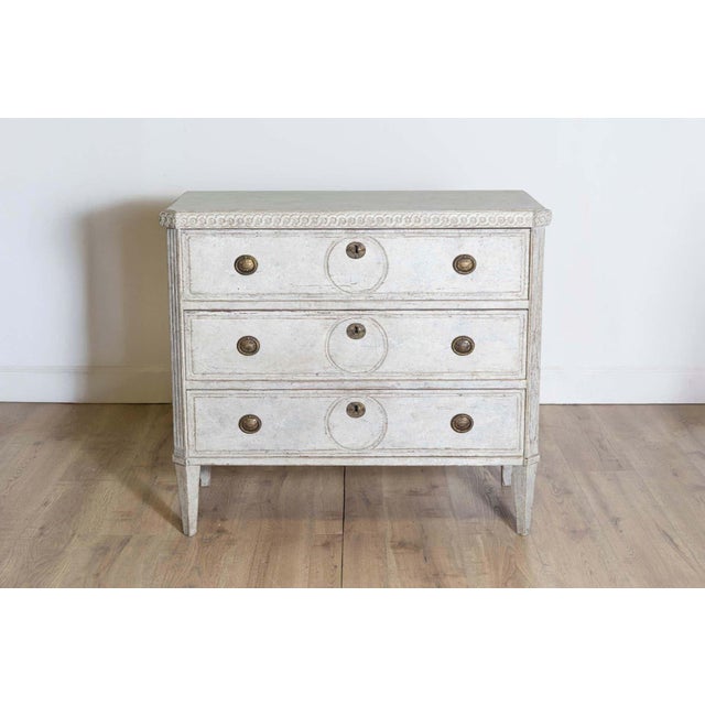 This early 20th-century Swedish chest of drawers, circa 1900, is a refined example of neoclassical Gustavian design....