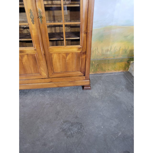 Louis Philippe period solid cherry wood glazed bookcase. An elegant two-door bookcase, beautifully presented, dating from...