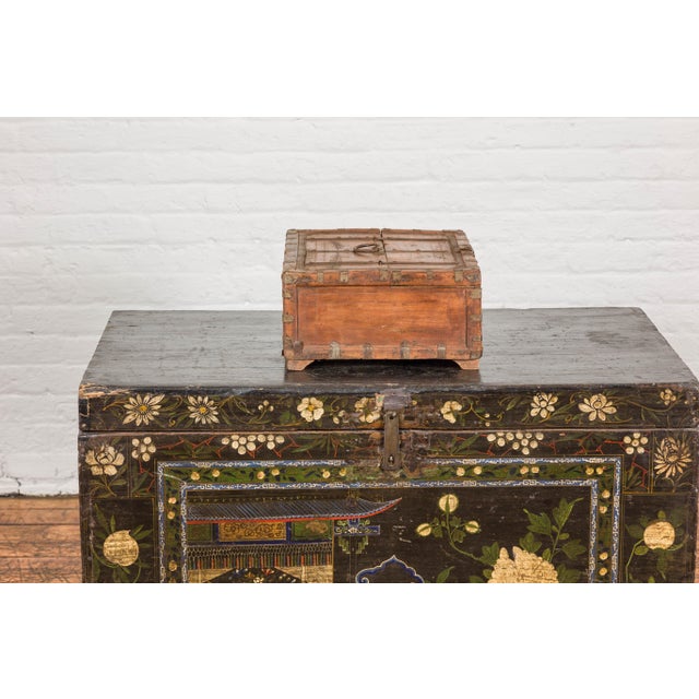 A rustic Indian wooden document box from the 19th century with brass details, partial opening top and petite bracket feet....