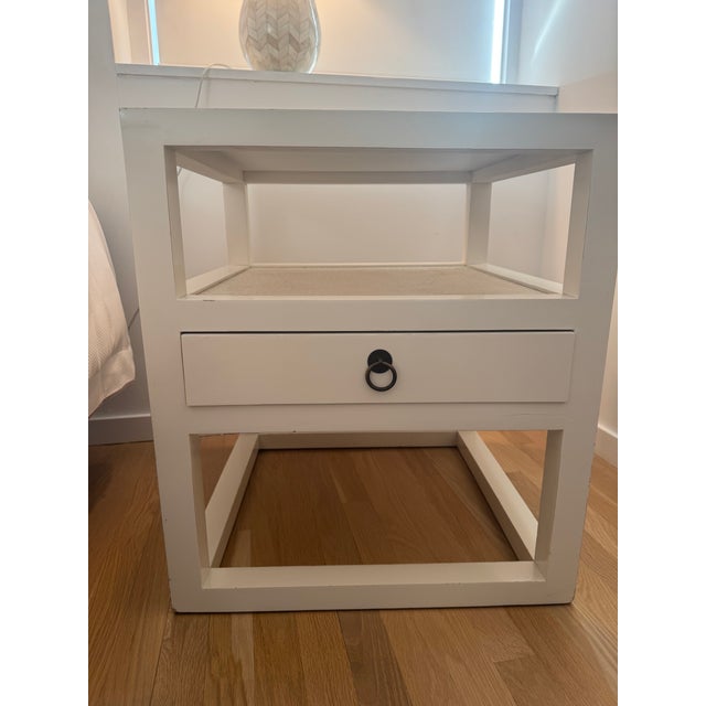 Pair of nightstands with shelf and drawer attributed to Bungalow 5. Textured, grasscloth-like top and shelf. Bronze hardware.