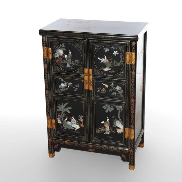 This Chinese credenza, dating from the 20th Century, presents a striking ebonized finish adorned with intricate gilt...