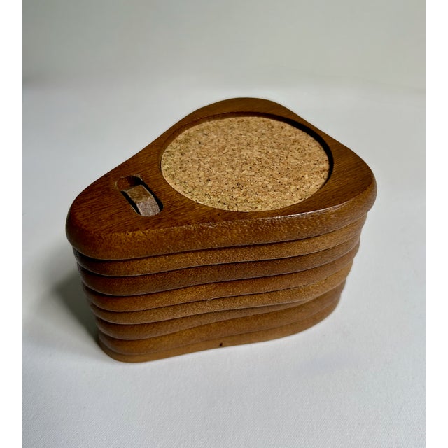 Vintage Set of Seven Mid-Century Modern Teak Wood and Cork Coasters. Featuring a distinctive handcrafted triangular design...