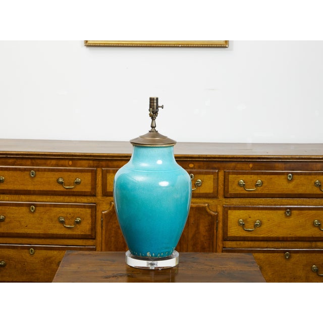 A turquoise Asian table lamp from the mid 20th century, with lucite base. Created during the midcentury period, this table...