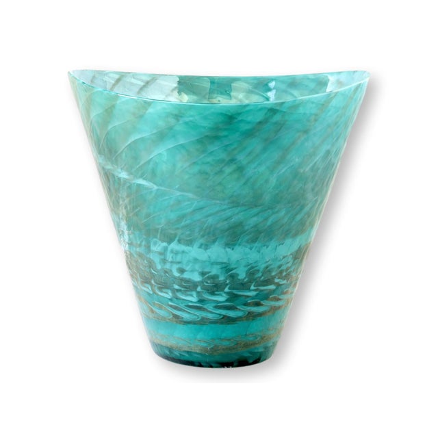 A striking handblown Murano art glass vase in luminous aquamarine tones, showcasing swirling layers of translucent color...