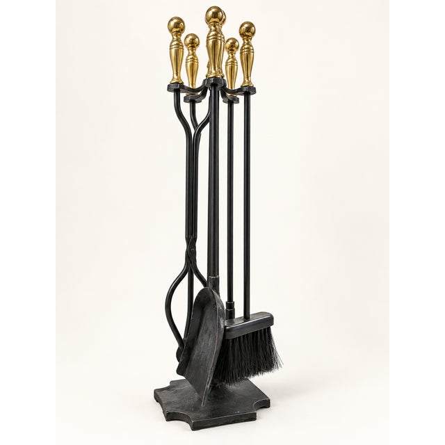 Substantial vintage fireplace tool set / fire companion set crafted from heavy cast iron with decorative brass handles,...