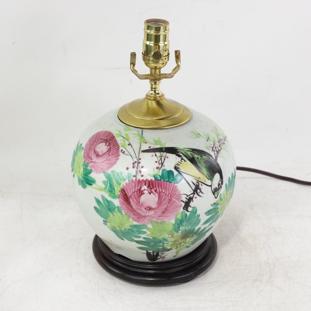 This antique table lamp is repurposed from an authentic white porcelain vase decorated in a vibrant Famille Rose palette....