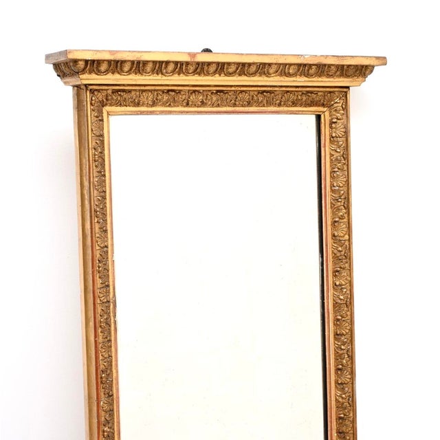 A gorgeous antique gilt wood mirror by Maple and Co, made in England and dating from around the 1890-1910 period. It is of...