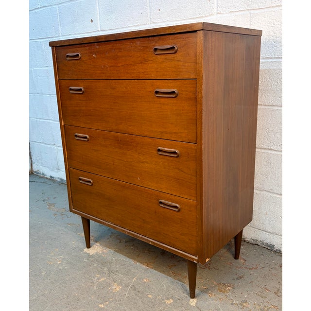 This Mid-Century Modern 4-drawer highboy dresser features a clean, minimalist silhouette and a beautiful wood grain...
