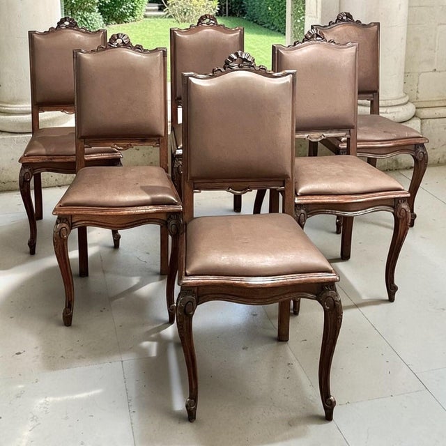 Set of six antique French Louis XVI dining chairs, hand crafted from solid oak and upholstered in their original leather,...
