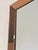 Elegant vintage wall mirror featuring a wide frame composed entirely of peach/rose-bronze tinted mirrored glass. The four...