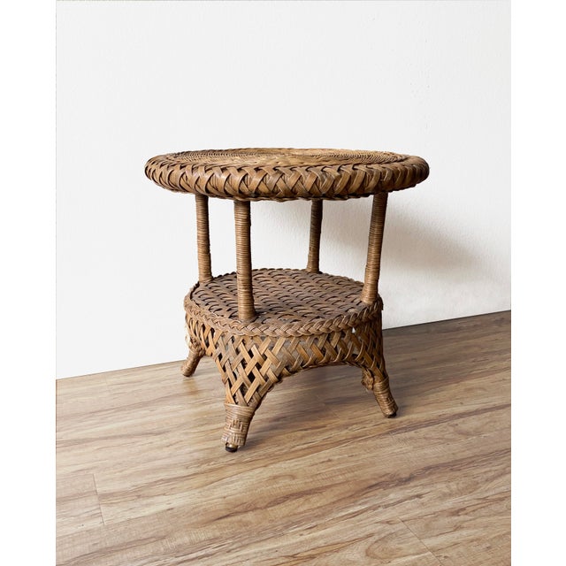 Wicker table with a natural finish, this lightweight, versatile piece features a lower shelf for books or accessories....