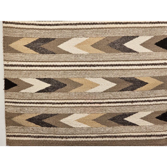Woven by hand in the third quarter of the 20th century by a Navajo (Din�) artisan of the American Southwest, this small...