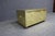 Brass clad two-drawer chest featuring an aviation-inspired riveted exterior, oval brass ring pulls, and dark wood bun...