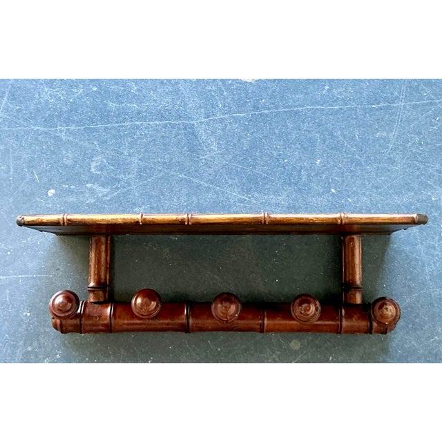 This sophisticated vintage wall rack is a masterful example of Hollywood Regency design, showcasing the enduring appeal of...