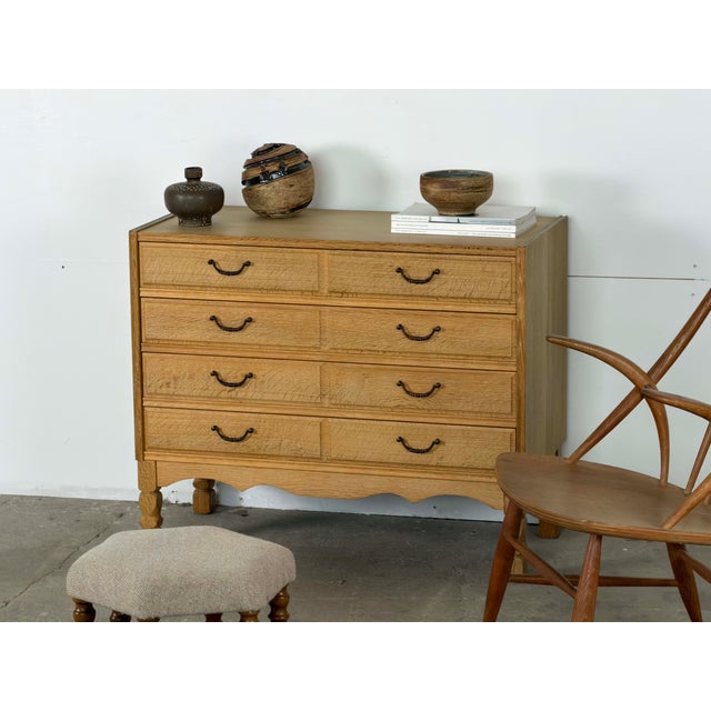 Danish chest of drawers in oak from the 1960s, designed with four broad drawers and a warm, strongly figured surface. The...