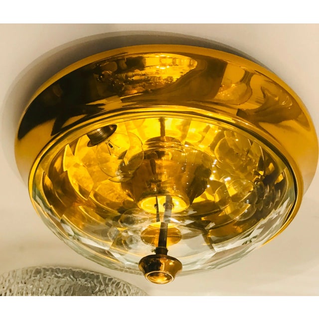 A wonderful 1970s Italian golden brass ceiling light with a thick faceted crystal shade designed by famed designer, Oscar...