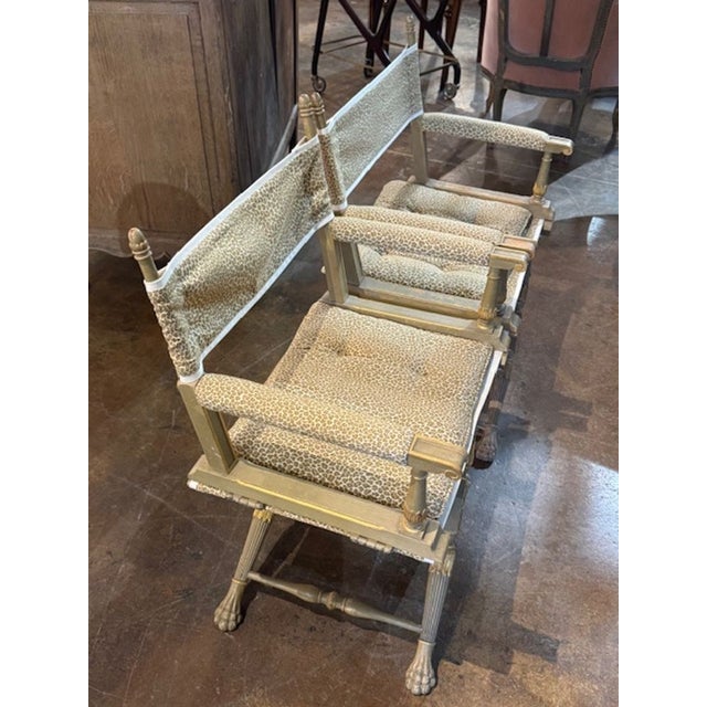 These Mid Century French carved and parcel gilt director's chairs add a fun touch of elegance to to any home. With the...