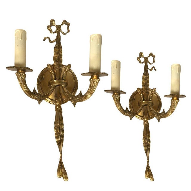 Vintage Pair of Solid Brass Wall-mount Sconces. These Louis XVI-style brass wall sconces epitomize timeless elegance with...