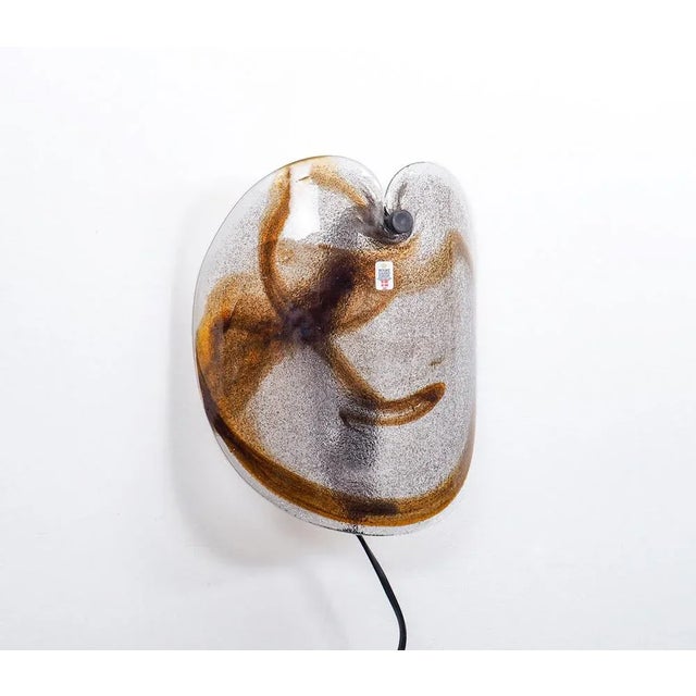 Vintage wall lamp made of thick glass designed by Per Lütken for Holmegaard, 1970s. Model: Glasplattelampet. A curved...