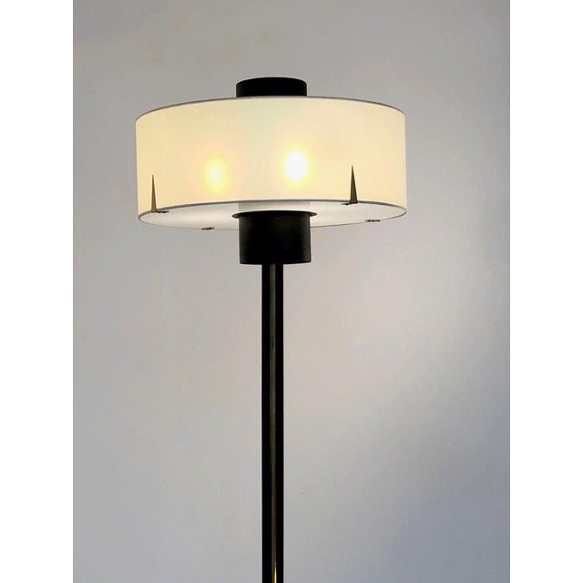 An exceptional tripod floor lamp, modernist, fifties, bauhaus, tripod base in black lacquered metal with 3 cylindrical...