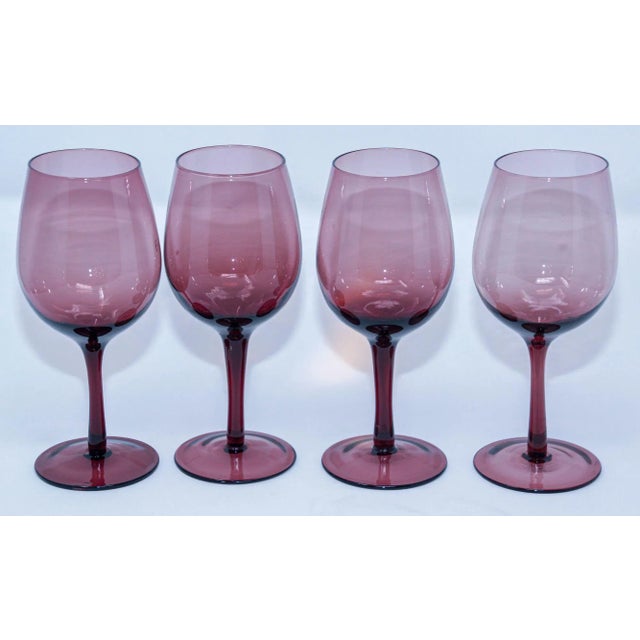 A beautiful set of four vintage French hand-blown stemmed wine or water glasses, circa 1980, in a sophisticated amethyst...