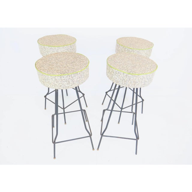 Vintage 1940s American made set of 4 iron bar stools in the style of Frederic Weinberg. These stools feature a thick 12.5"...