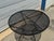 Classic vintage wrought iron patio table featuring a round expanded metal mesh top and sculptural iron base. Believed to...