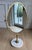 An exceptional and substantial oversized solid brass and Carrara marble vanity mirror attributed to Charles Hollis Jones,...