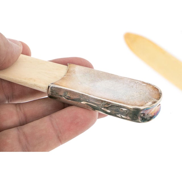 A set of three antique, circa 1817, page turners or paper knifes with a sterling silver mounted ribbed handle and bone...
