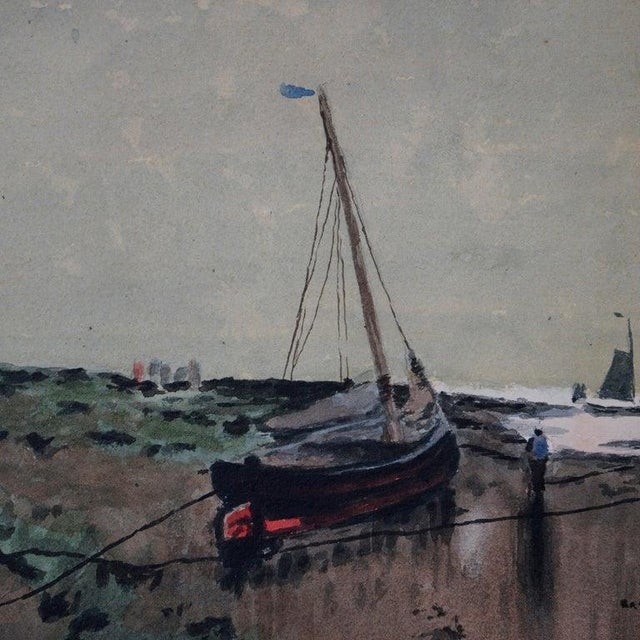 An antique seascape offers watercolor scene of shoreline with fishing boats and figures, artist signed lower left as...