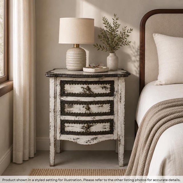Anchor your sanctuary with the enchanting charm of this one-of-a-kind Transitional Distressed white Nightstand. This 30""...