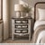 Anchor your sanctuary with the enchanting charm of this one-of-a-kind Transitional Distressed white Nightstand. This 30""...