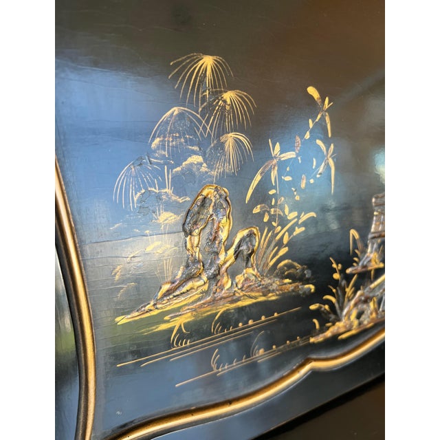 Chippendale style slant top desk in black lacquered wood. Red brilliant lacquered inferior part opening by three drawers...