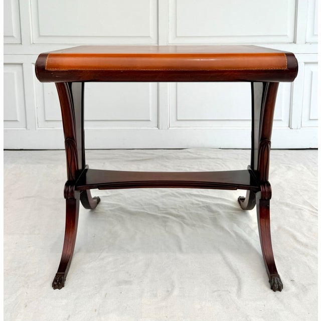 Here is a beautiful, mahogany wood side table with a scroll shaped top and wonderfully splayed legs. The top is covered in...