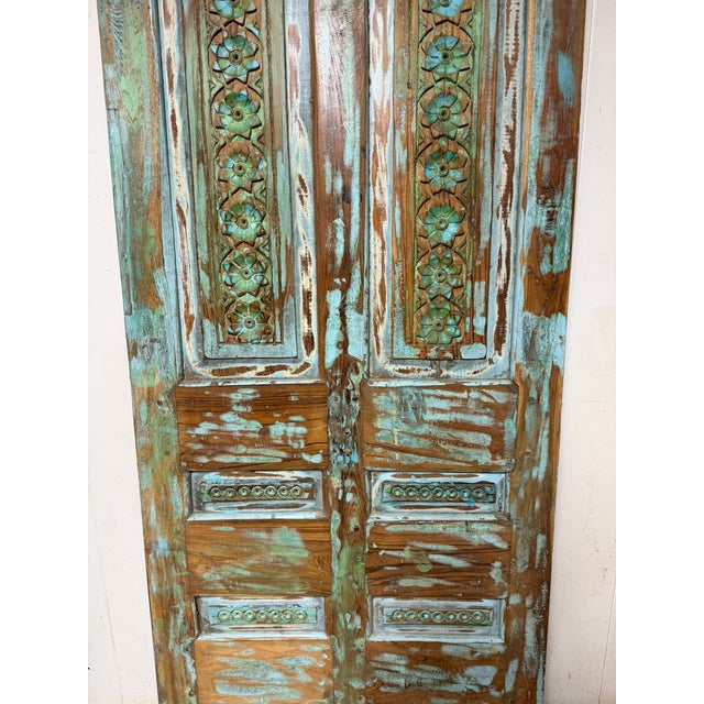 Make a dramatic entrance with this vintage hand-carved wooden barn door. Crafted from solid, aged hardwood, it features...