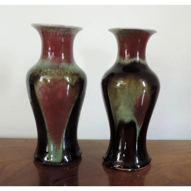 Pair antique 19th c. Chinese flambe oxblood porcelain baluster shaped vases. Decorated in shades of red, black and green....