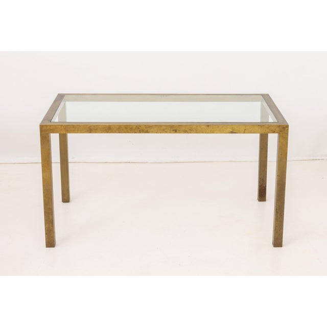 Modern Glass Top Brass Dining Table, with rectangular glass top. 29" H x 54" W x 30" D. Provenance: From a 201 E 66th...