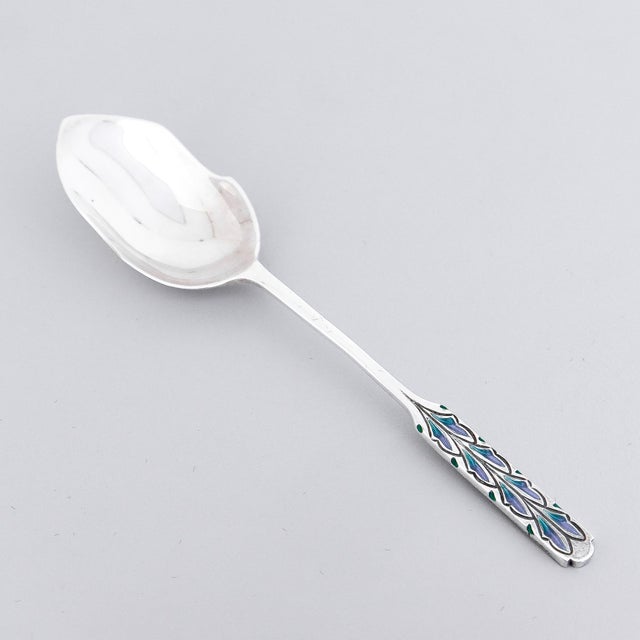 A fine set of 6 English silver and enamel demitasse spoons Designed by Bernard Cuzner for Liberty & Co. In sterling...