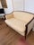 Elegant vintage French-style settee featuring a beautifully crafted dark mahogany-toned wood frame with graceful curved...