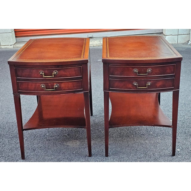A pair of Mid 20th century Holliwood Regency Style Solid Genuine Mahogany and Stenciled Tooled Leather Top double drawer...