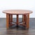 This Thos Moser dining set features a round cherry wood table with two leafs and eight matching chairs. The chairs have...