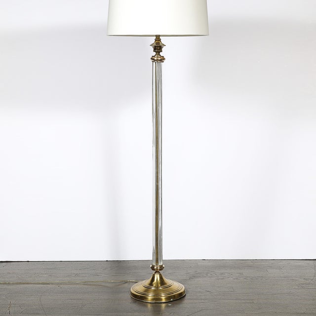 This Art Deco fluted glass and brass floor lamp, crafted in America circa 1935, is an elegant example of the era’s...