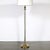 This Art Deco fluted glass and brass floor lamp, crafted in America circa 1935, is an elegant example of the era’s...