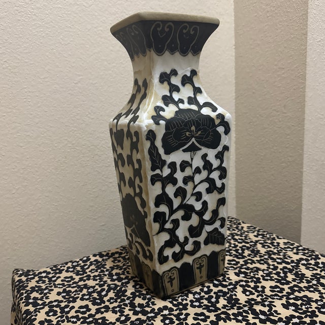 This is a beautiful vintage ceramic vase featuring striking black and white designs. The vase has a tall, square-based...