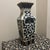 This is a beautiful vintage ceramic vase featuring striking black and white designs. The vase has a tall, square-based...