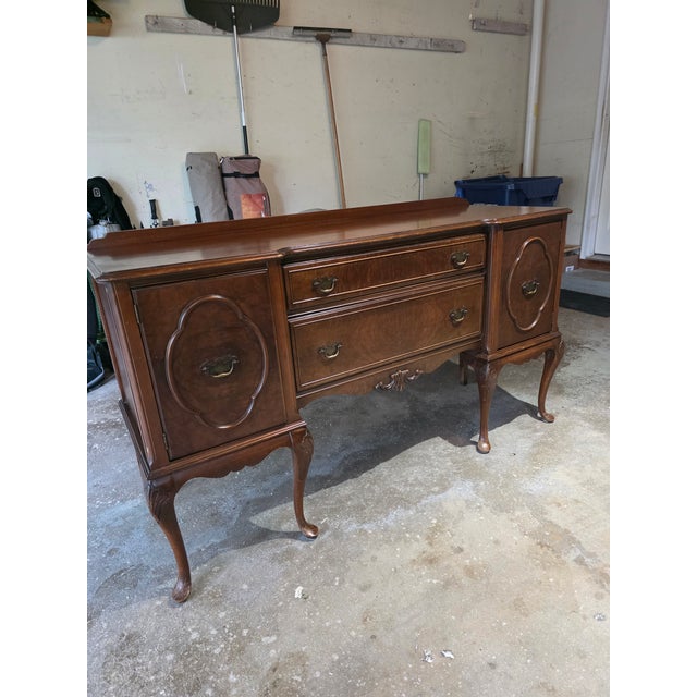 This sideboard represents the American Colonial Revival movement of the early 20th century, when furniture makers looked...